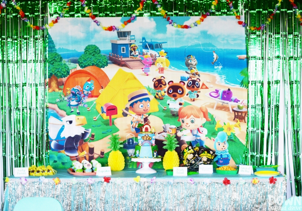 Closeup of a party food table and Animal Crossing backdrop for the Animal Crossing Birthday Party.