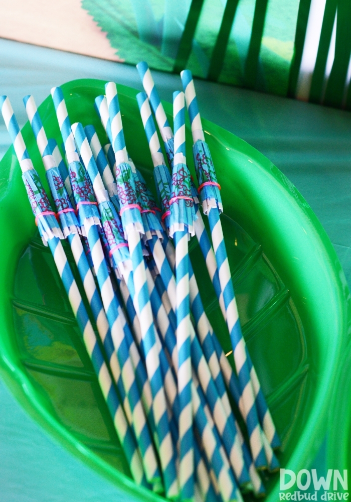 Umbrella straws sitting in a leaf shaped bowl.