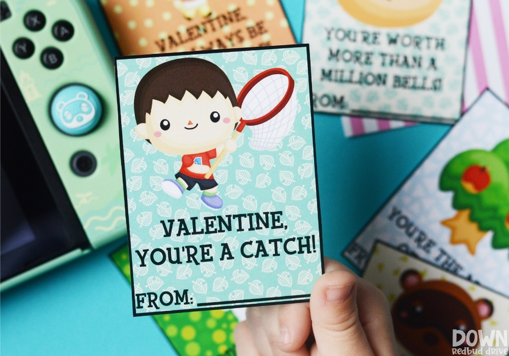 A child holding a valentine that says "Valentine, you're a catch!" on it.