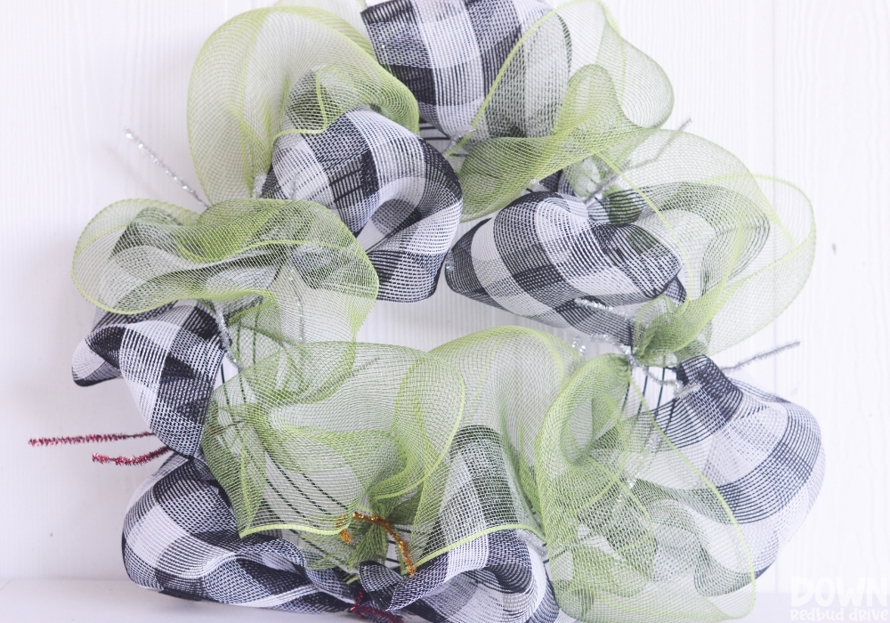 Green deco mesh attached to a wreath form.