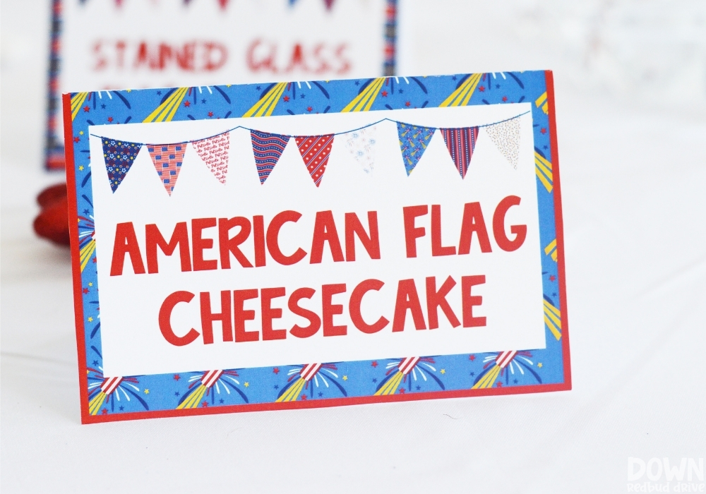 Closeup of a 4th of July party food card for "American Flag Cheesecake".