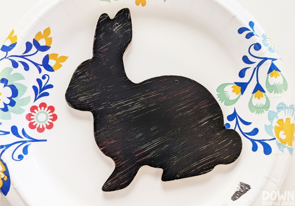 Close up of the bunny decoration after it's been painted with a coat of black paint.