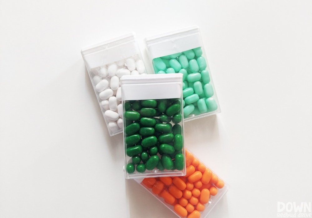 Overhead shot of 4 different kinds of tic tacs with their labels removed.