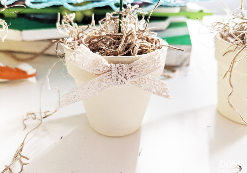 A bow glued to the front of the DIY Easter Egg Topiary.