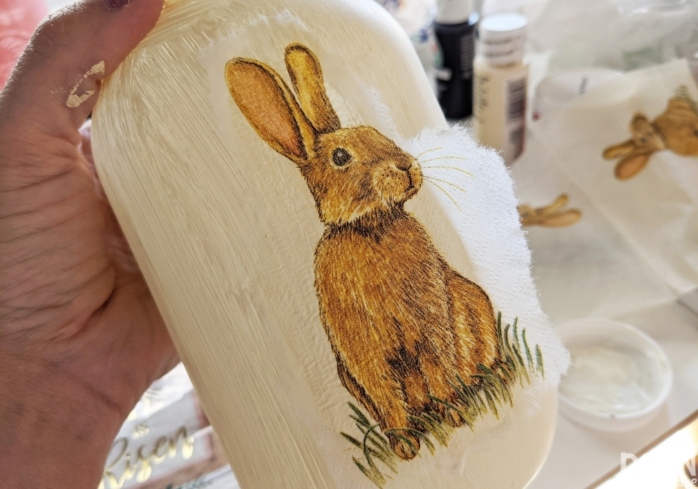 Close up of the bunny napkin being placed on a mason jar.