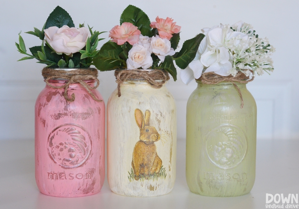 The finished DIY Easter napkin jars with flowers in them.