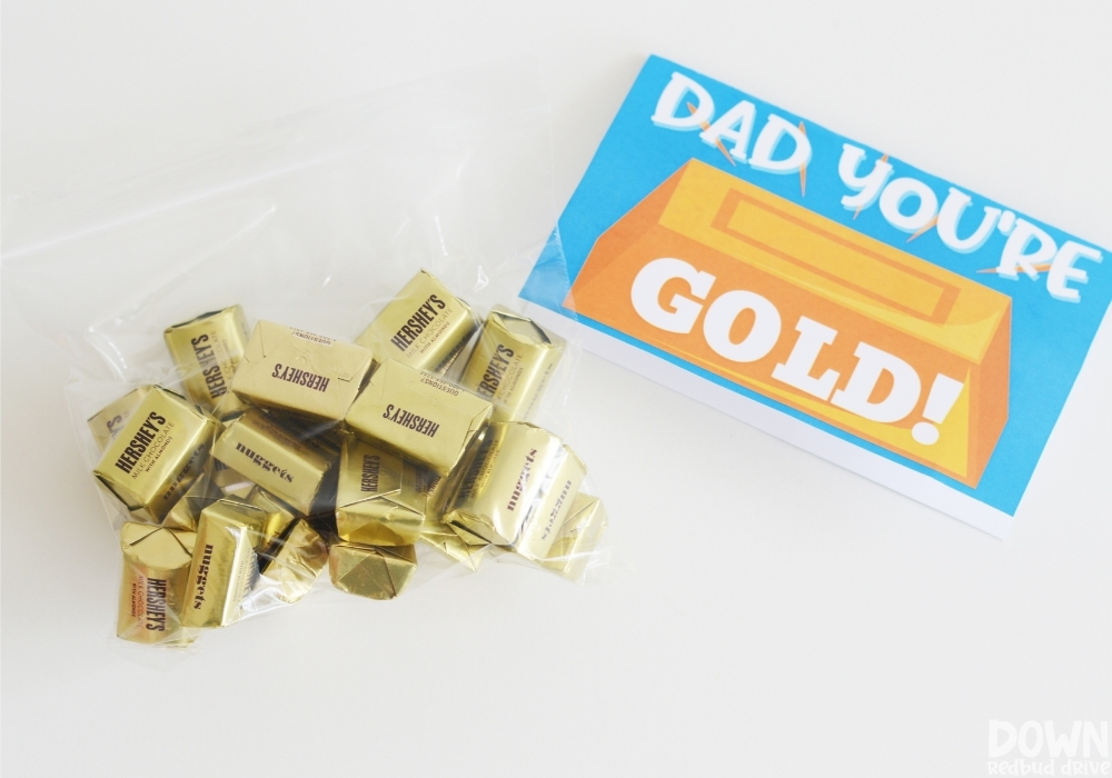 Close up of a bag of Hershey's Gold Nuggets next to a printable tag that says "Dad You're Gold!"