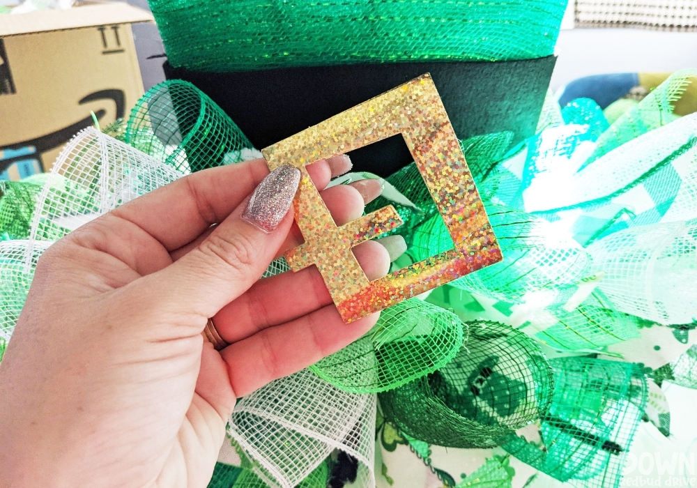 Gold hat buckle to attach to a hat wreath for St. Patrick's Day.