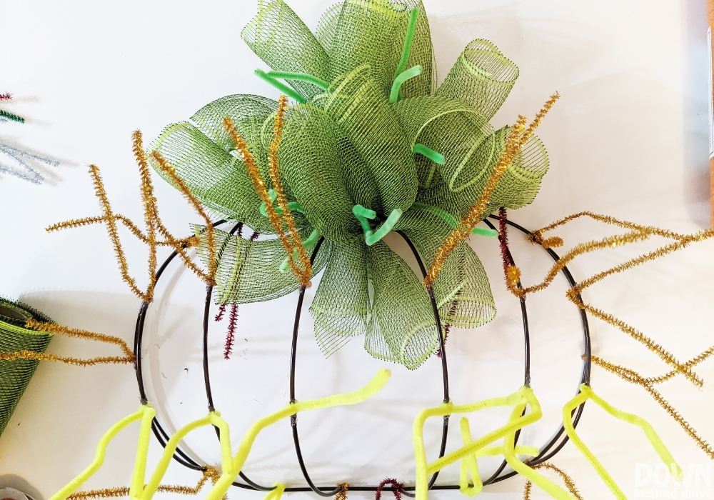 The green deco mesh finished being attached to the wreath form for the DIY Mesh Pumpkin Wreath.