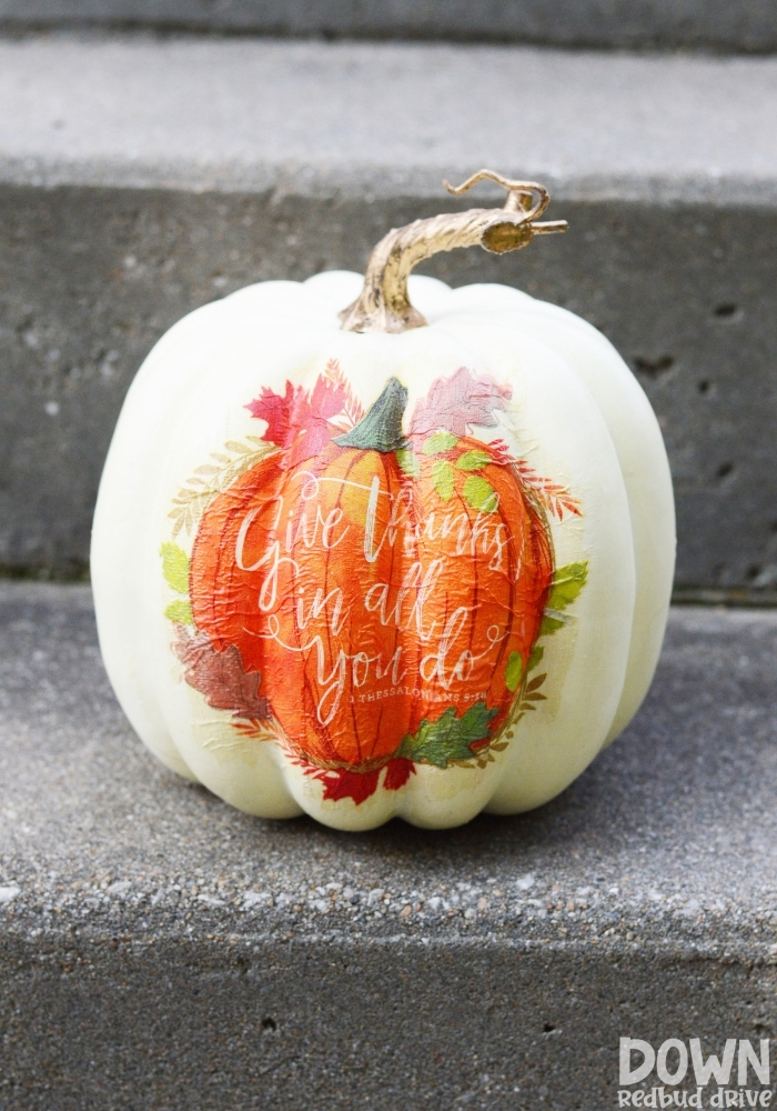 Tall image of the finished DIY Napkin Pumpkin on a concrete step.