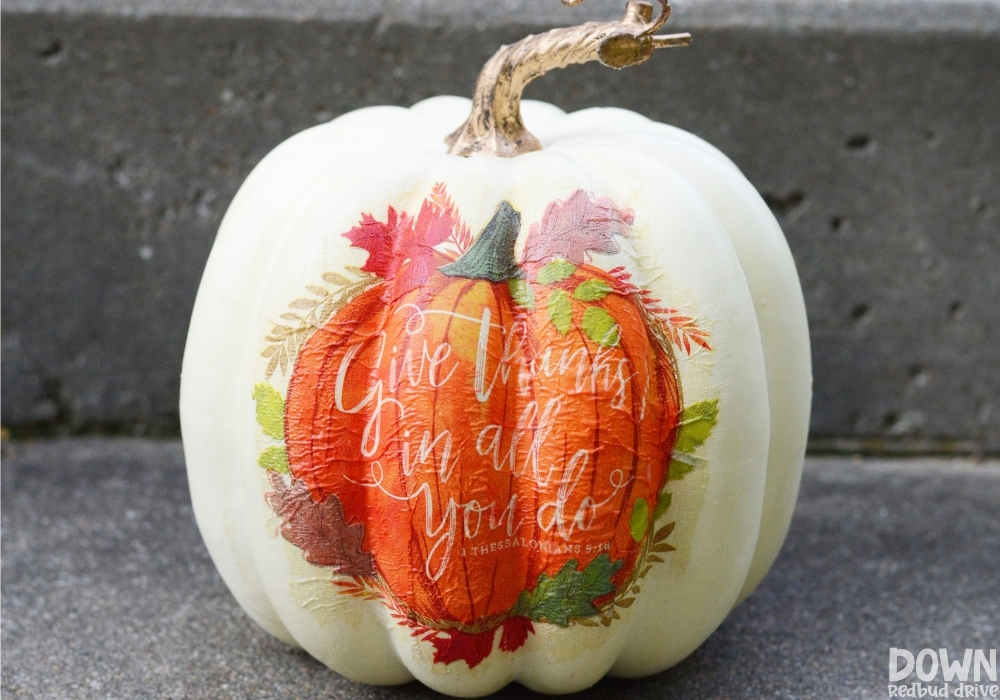 Picture of a finished DIY Napkin Pumpkin sitting on an concrete step.