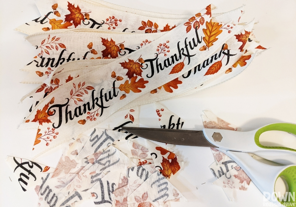 Sections of "Thankful" fall ribbon cut for the DIY Thanksgiving Mesh Wreath.