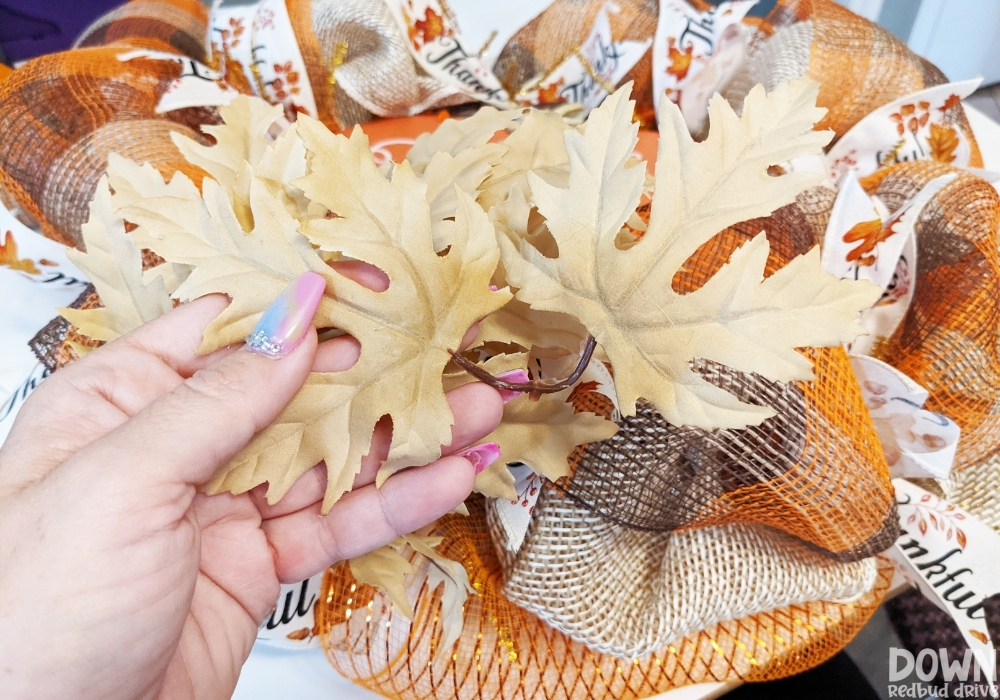 Closeup of plastic floral leaves for the fall deco mesh wreath DIY.