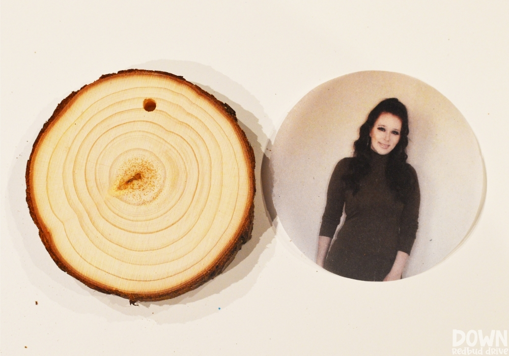 A blank wood slice ornament with a picture cut into a circle for the photo transfer.