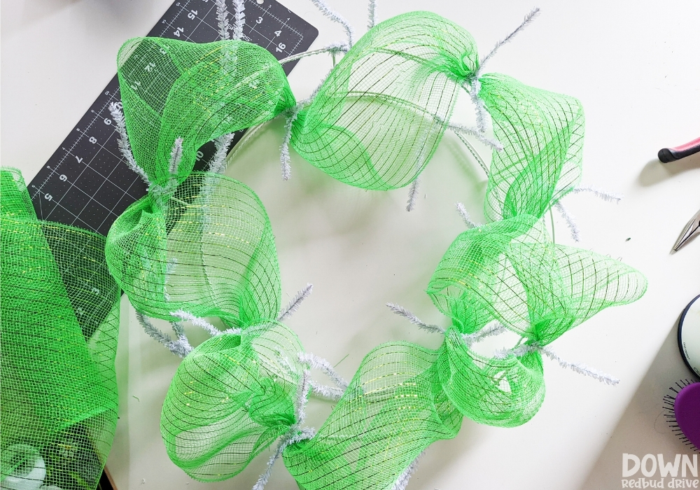 Closeup of the green mesh added to the wreath form.