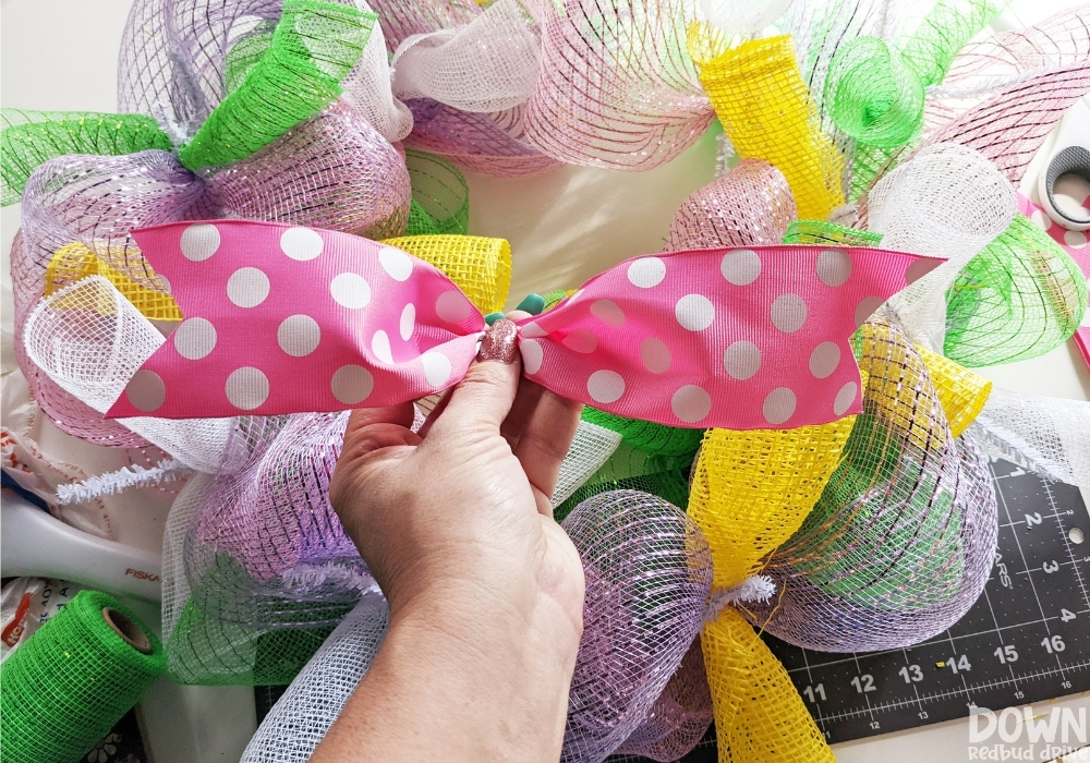 The pink polka dot bow for the DIY Easter mesh wreath.