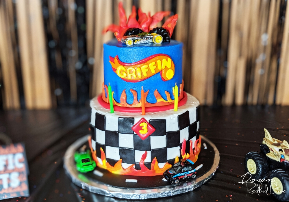 hot wheels birthday cake sitting on a black table