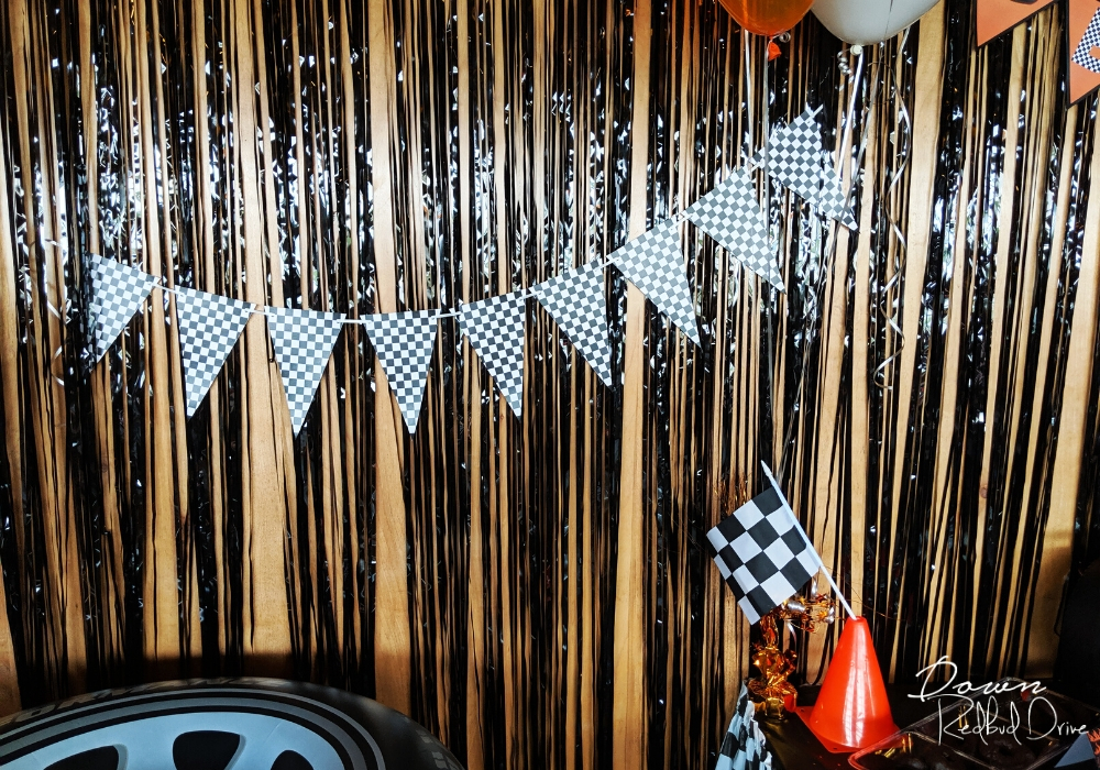 black and white checkered flag banner on a wall with black streamers