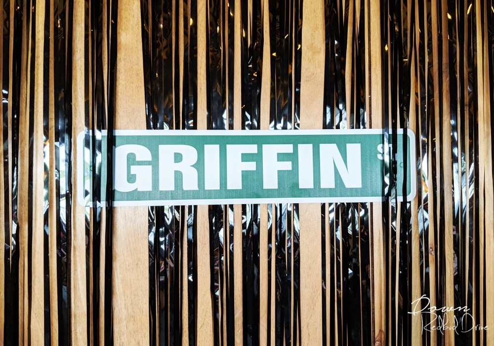 street sign on the wall that says griffin st with black streamers