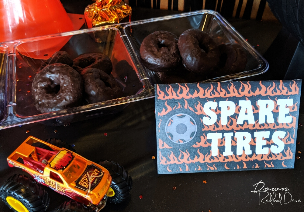 mini chocolate donute in a clear serving container with a sign that says spare tires