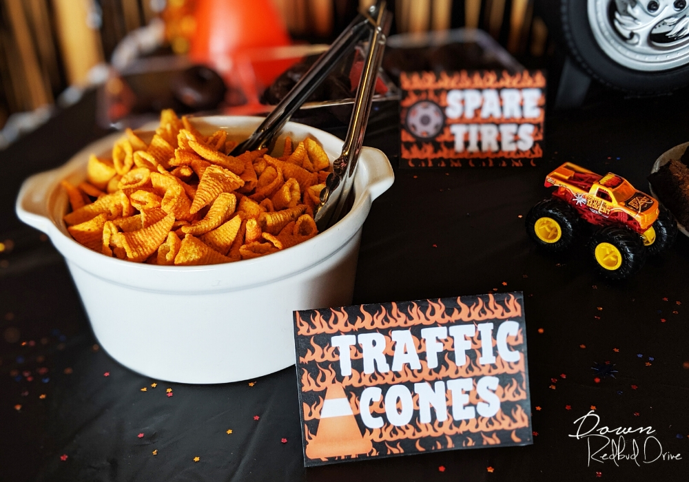 bugles in a white bowl on a black table with a sign that says traffic cones