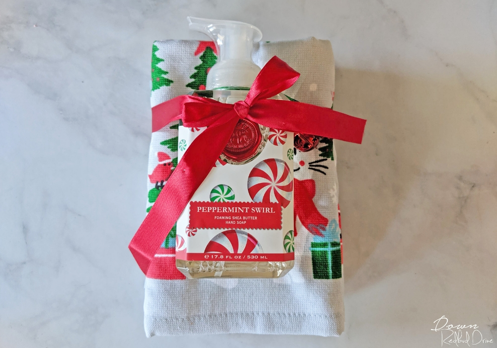 christmas kitchen towel and hand soap tied in a red ribbon