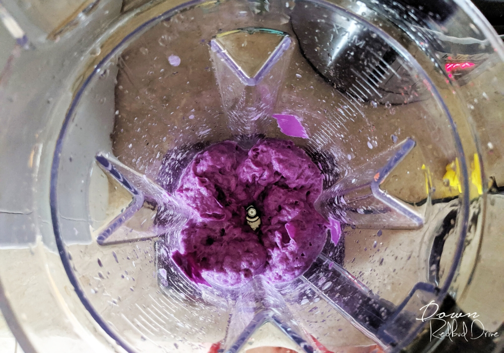 purple paper pulp in the bottom of a blender