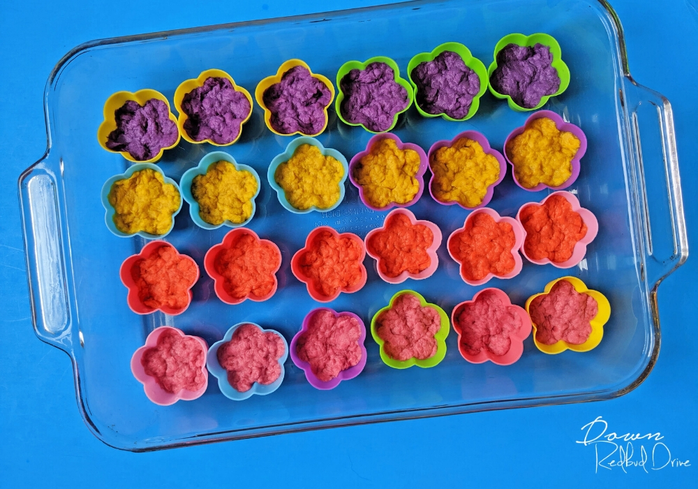 flower silicone molds halway full of wet paper pulp for seed bombs