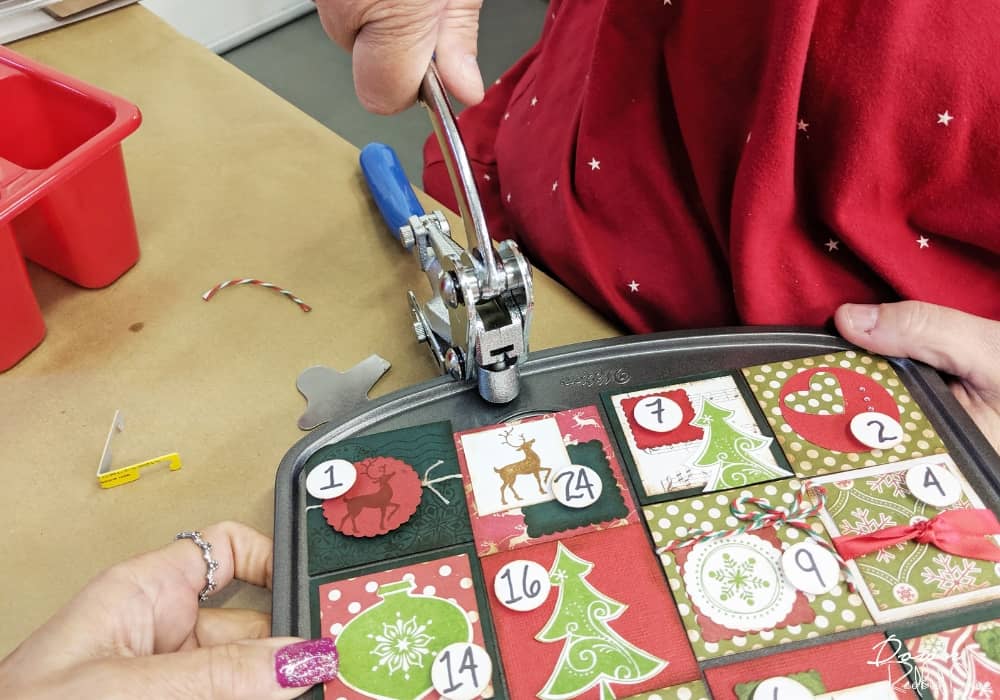 punching holes in a muffin tin advent calendar