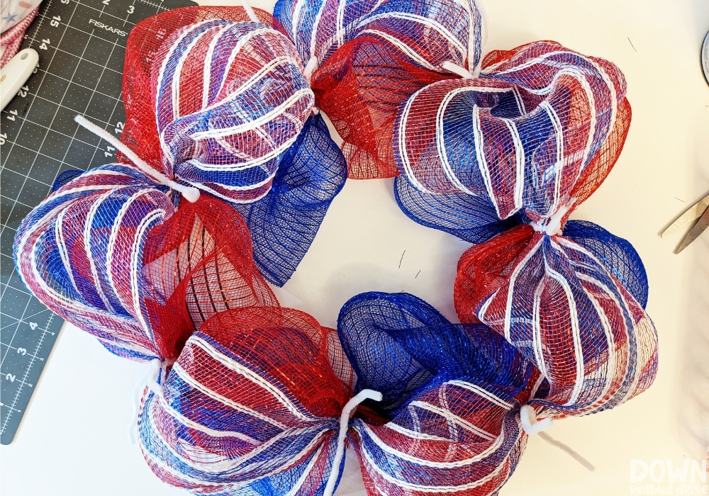 Red and white stripped deco mesh added to a wreath form for the Patriotic Deco Mesh Wreath.