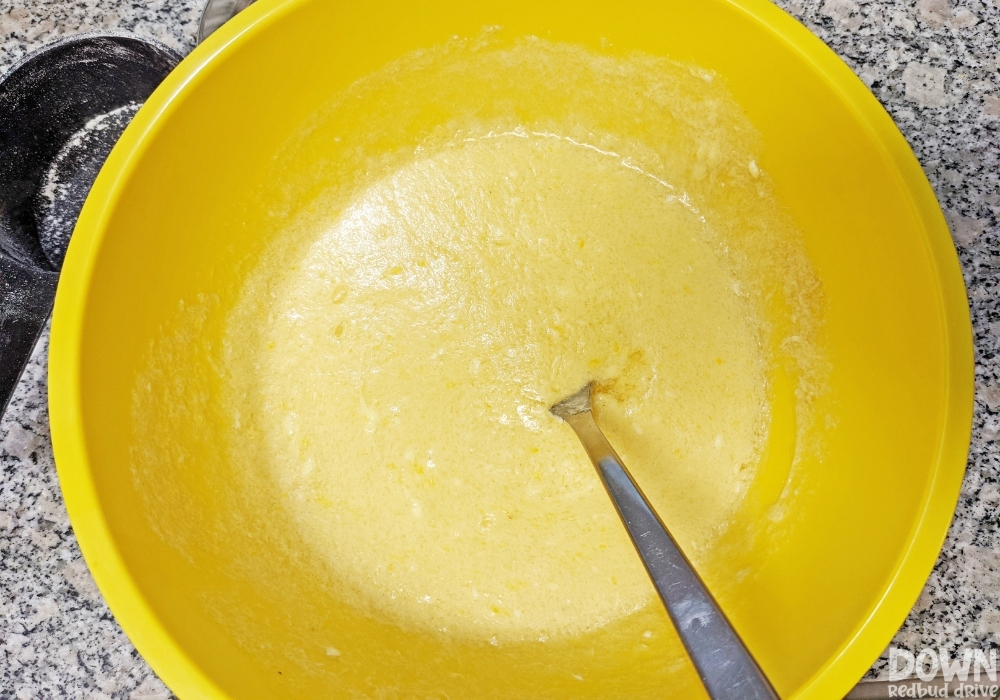 Overhead view of the wet ingredients added to a mixing bowl for the Pumpkin Sprinkle Cookies.