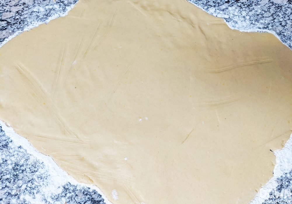 The dough rolled out for the pumpkin themed sprinkle cookies.