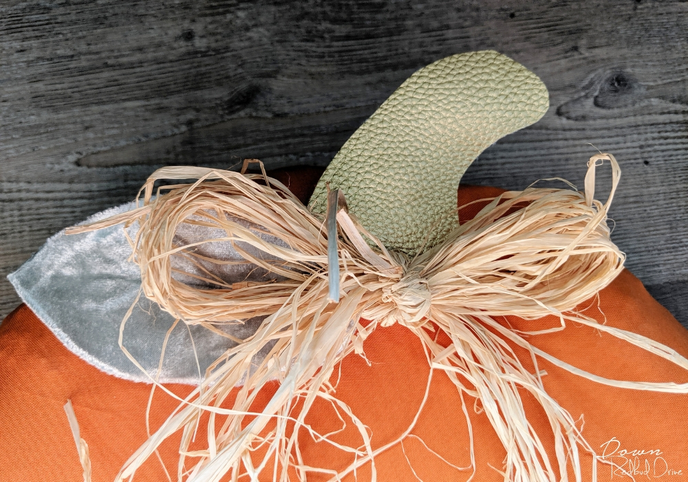 raffia bow on top of a pumpkin wreath diy