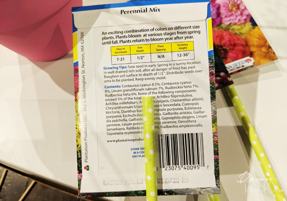 taping green paper straws to the back of a seed packet