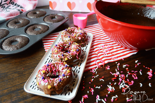 Valentine Donuts on a white tray next t a red mixing bowl.