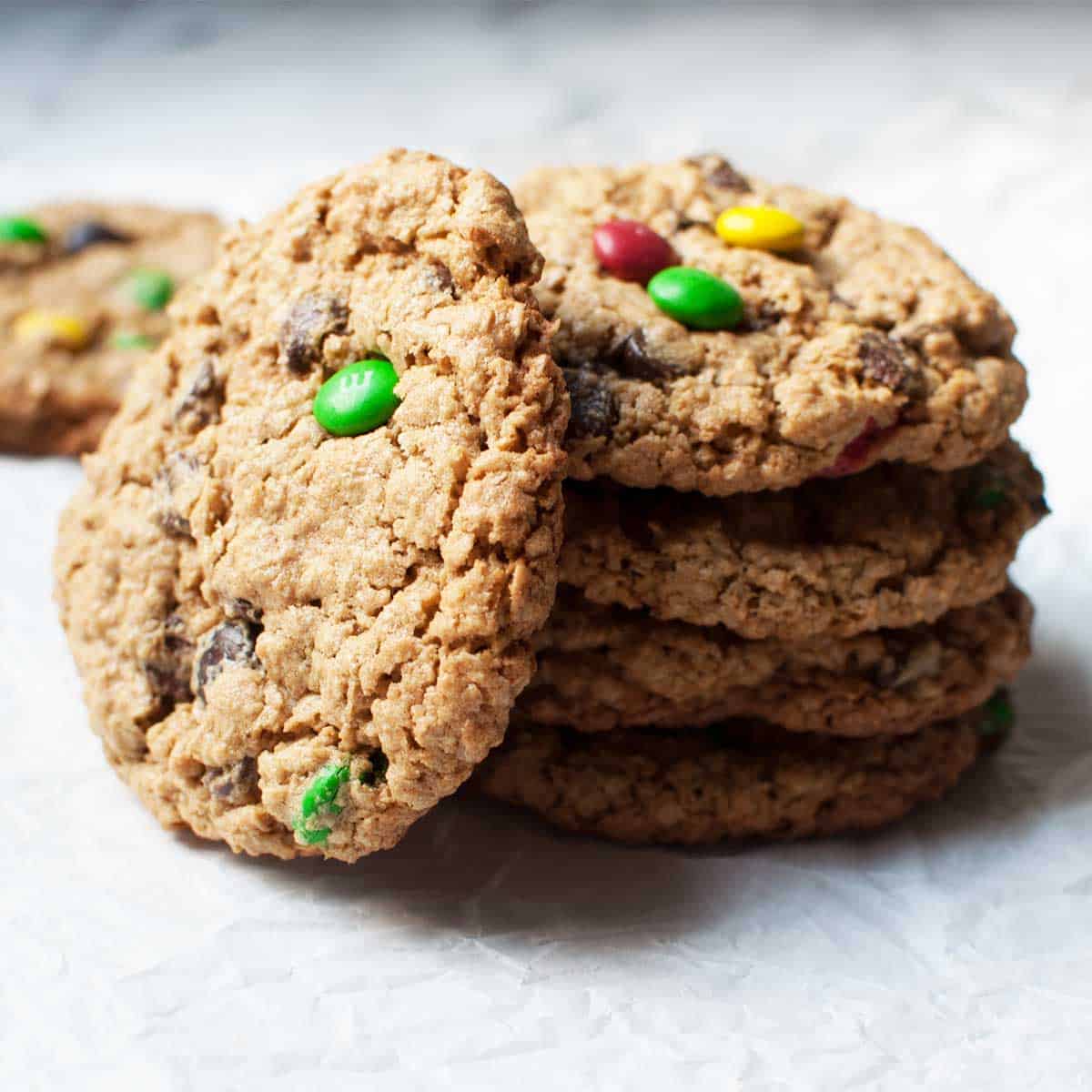 a pile of amish monster cookies on white parchment