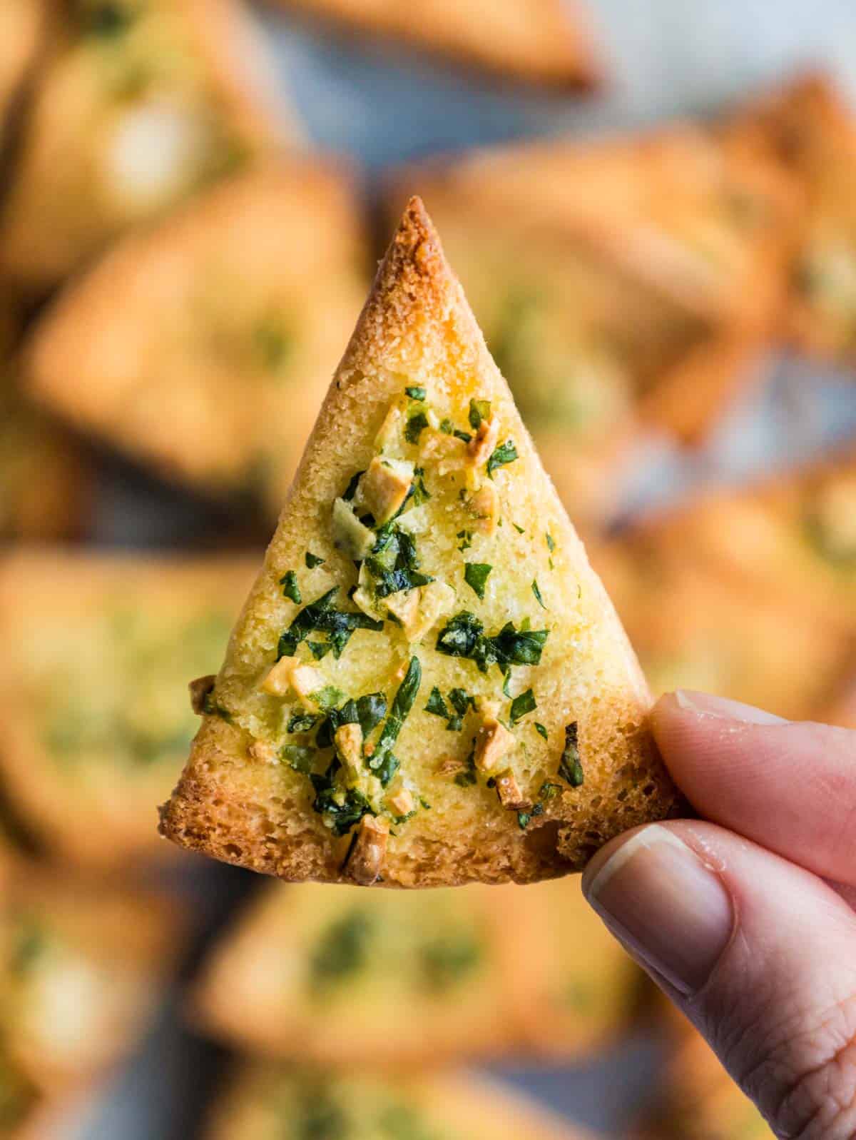 Garlic pita bread toast chip triangle shown close up