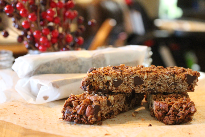 a stack of homemade granola bars both wrapped and unwrapped.