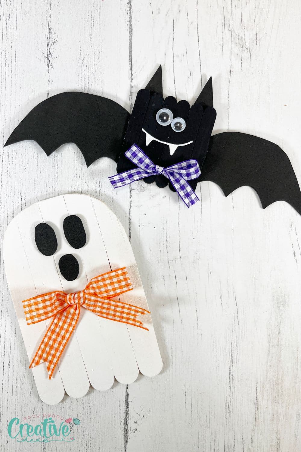 Finished halloween bat and ghost made out of popsicle sticks