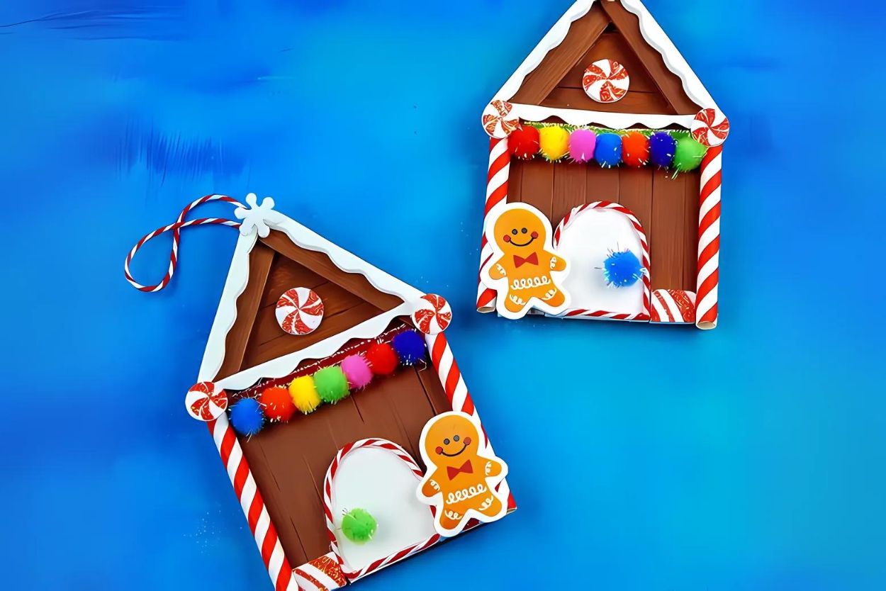 DIY gingerbread houses made out of popsicle sticks and pom-poms