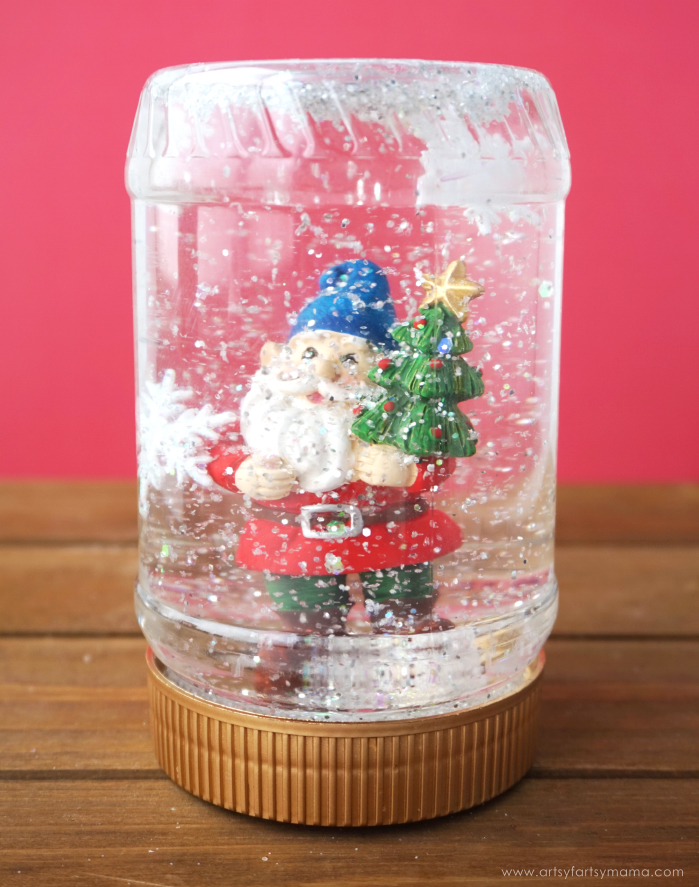 peanut butter jar turned into a christmas snow globe