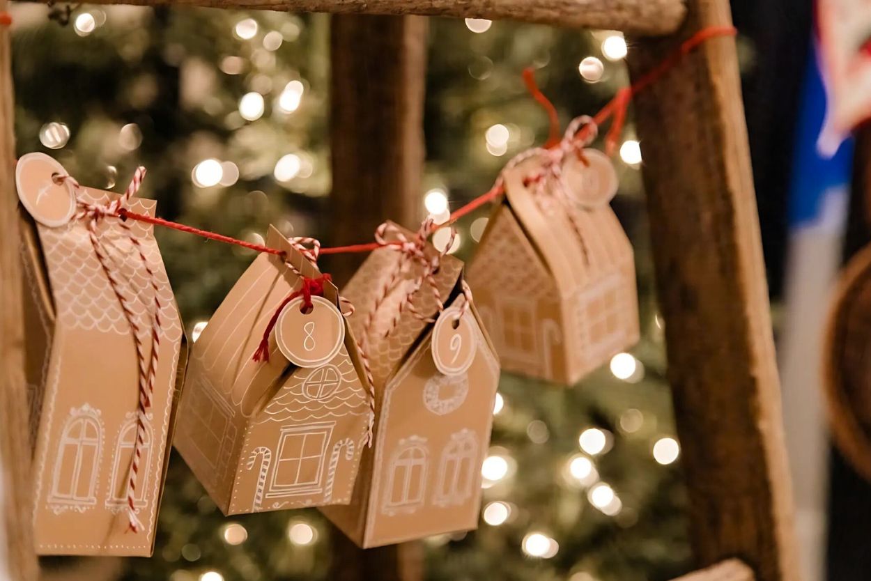 kraft paper gingerbread house strand in front of a christmas tree