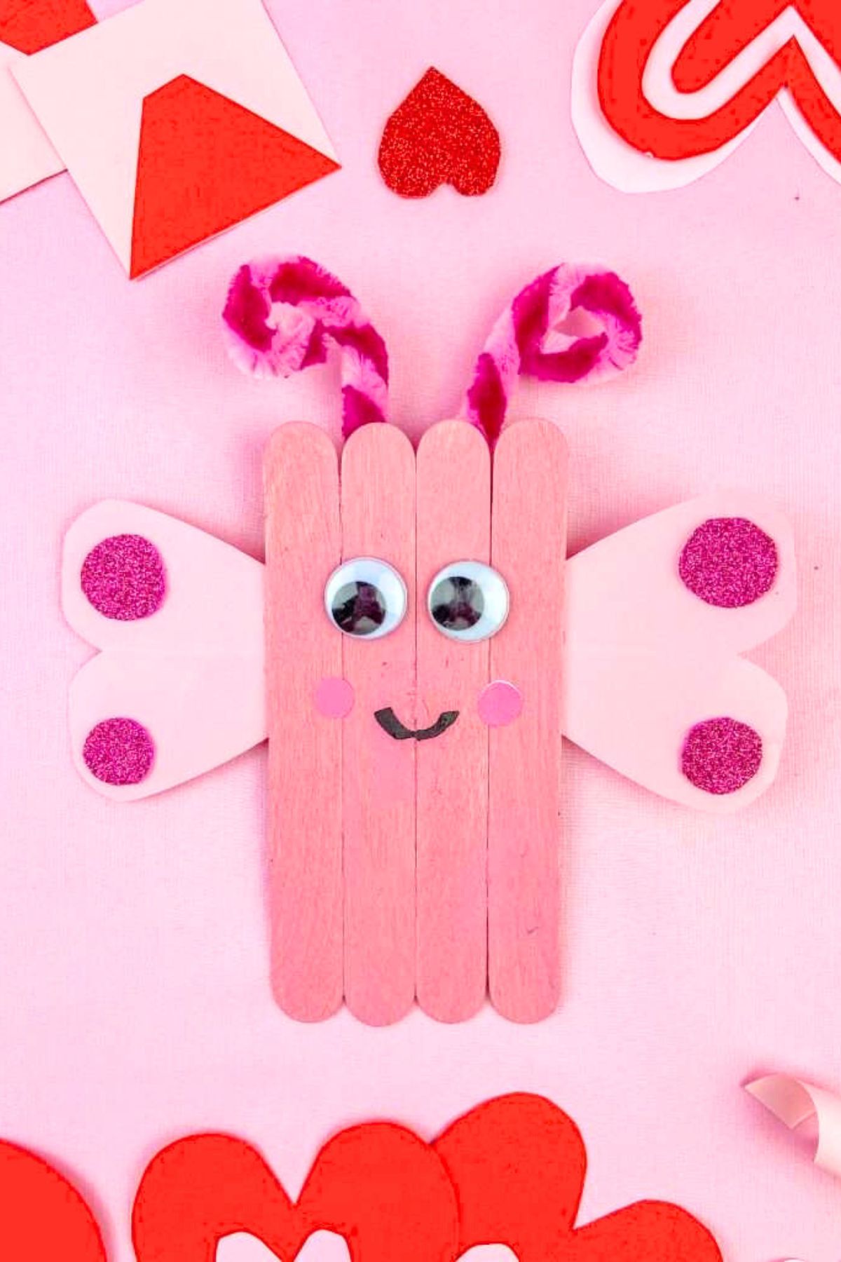 Valentine's Day love bug craft made from popsicle sticks.